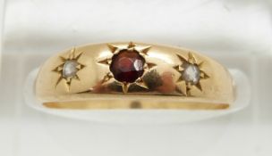 A 9ct gold ring set with a garnet and rose cut diamonds in a star setting, 2.8g, size N