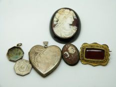 Victorian jet brooch set with a cameo, a silver heart locket, Victorian brooch, cameo brooch etc