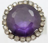 A white metal ring set with a synthetic purple sapphire surrounded by white sapphires, 11.5g, size