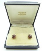 A pair of 9ct gold earrings set with clusters of garnets