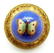 Victorian brooch set with an enamel butterfly on a blue guilloché enamel ground, verso glass