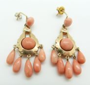 A pair of 9ct gold earrings set with five pear drop coral beads and two coral cabochons to each