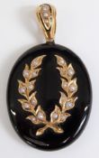 Victorian black enamel pendant set with seed pearls in a foliate design, verso a glass locket