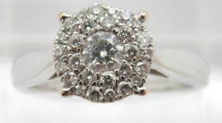 An 18ct white gold ring set with a cluster of diamonds, total 0.5ct, 4.8g, size P