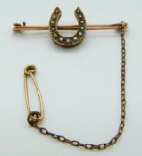 Victorian yellow metal brooch set with seed pearls in the form of a horseshoe