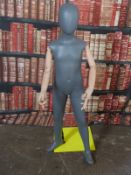 Haberdashery/shopfitting modern articulated child mannequin supported by a removable steel column to
