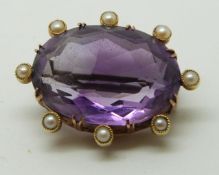 Victorian/Edwardian brooch set with a large oval cut amethyst surrounded by seed pearls