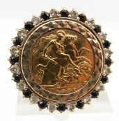 A 1982 gold half sovereign set into a 9ct gold ring set with paste set border, 12.2g size L