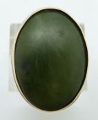 A 9ct gold ring set with a large nephrite jade cabochon, 11.7g, size O