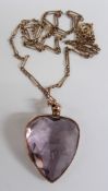 Edwardian pendant set with a large heart cut amethyst, 2.5cm long on a 9ct gold chain, 9.9g,