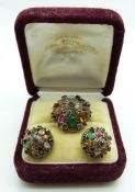 A yellow metal ring set with sapphires, citrine, topaz, garnet, tiger's eye, etc in a large cluster,