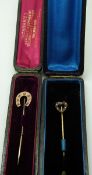 A horseshoe stick pin set with diamonds and rubies in original box and a Victorian heart shaped