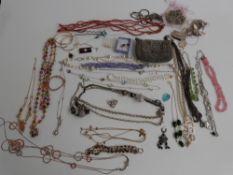 A collection of costume jewellery including beads, pendants, tiger's eye bracelet, etc
