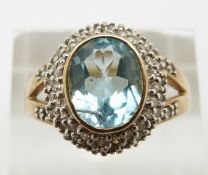 A 9ct gold ring set with oval cut aquamarine and diamonds, 4.8g, size U