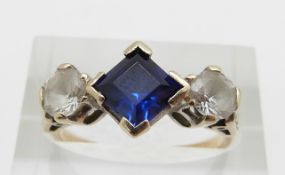 A 9ct gold ring set with a synthetic sapphire and paste, 3.2g, size O