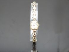 Everite 9ct gold ladies wristwatch with black hands, Roman numerals and silver dial, on gold