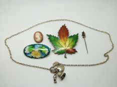 A silver maple leaf brooch set with enamel, silver necklace, silver cameo, cloisonné brooch and a