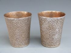 Pair of retro style hallmarked silver beakers with bark effect finish, London 2003 with 999 grade