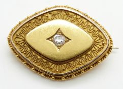 Victorian Etruscan Revival gold  brooch set with an old mine cut diamond measuring approximately 0.