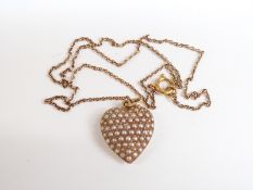 Edwardian 15ct gold heart pendant set with seed pearls and a diamond.