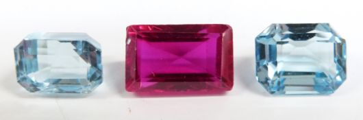 Two emerald cut aquamarines, measuring approximately 2.7ct and 2.6ct and a rectangular cut synthetic