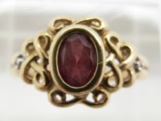 A 9ct gold ring set with an oval cut garnet, 2.8g, size P
