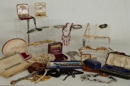 A large collection of costume jewellery including necklaces, green paste necklace, copper jewellery,