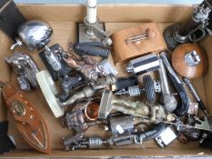 Approximately 25 mainly table top novelty cigarette lighters including camel, knight, skier, boat
