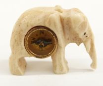 A bone compass fob in the form of an elephant