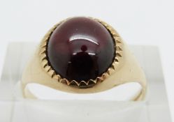 A 9ct gold ring set with a garnet cabochon, 3.4g, size N