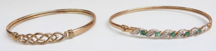 A 9ct gold bangle with a Celtic design and a 9ct gold bangle set with emeralds and diamonds, 9.2g