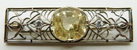 A 1920s Art Deco brooch set with a natural untreated cushion cut yellow Sri Lankan sapphire
