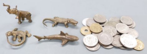 Four cast brass miniature figures including a particularly well cast lizard and a quantity of coins