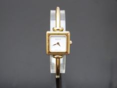 Gucci gold plated ladies wristwatch ref. 1900L with gold hands, white dial and quartz movement, on