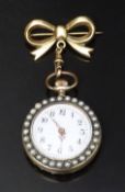 Silver gilt keyless winding open faced pocket watch on 9ct gold ribbon brooch with pearl set case,