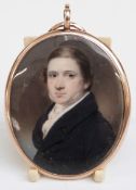 Victorian gold double sided locket set with a painted ivory miniature of a young gentleman, verso