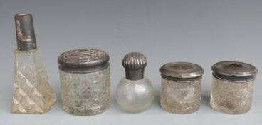 Five Victorian and later hallmarked silver topped dressing table pots and bottles, height of tallest