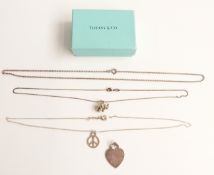 Three necklaces including elephant and peace symbol and a pendant marked 'return to Tiffany & Co.'