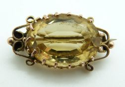 Victorian brooch set with an oval cut citrine within scrolling border, 5.4g, 2.8 x 1.3cm