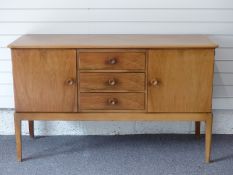 Gordon Russell of Broadway sideboard with three drawers flanked by two cupboards, W142 x D49 x