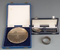 Three feature hallmarked items comprising Silver Jubilee pin dish, diameter 11cm, napkin ring and