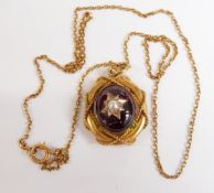 Victorian mourning pendant set with a garnet cabochon and pearl, with a rope effect around the mount