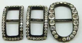 Three Victorian buckles set with paste, comprising one matched pair and one oval example