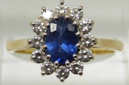 An 18ct gold ring set with an oval cut sapphire measuring approximately 1ct surrounded by