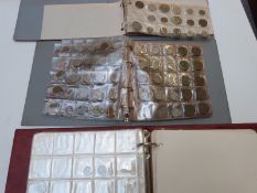 An amateur collection of UK and overseas coins mostly in albums, includes small silver content and a