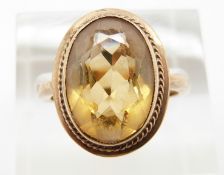 A 9ct gold ring set with an oval cut citrine, 4.6g, size N