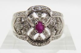 An 18ct white gold ring set with a ruby and diamonds, 6.8g, size N