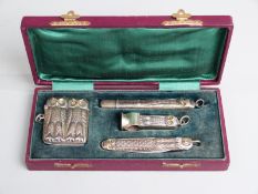 Cased German white metal novelty vesta, cigar cutter, penknife and pencil holder, all formed as owls