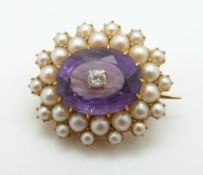 Edwardian brooch set with an, oval cut amethyst surrounded by seed pearls with a diamond to the