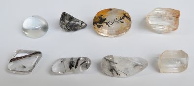 A moonstone cabochon, quartz with rutile inclusions, quartz with dendritic agate, etc